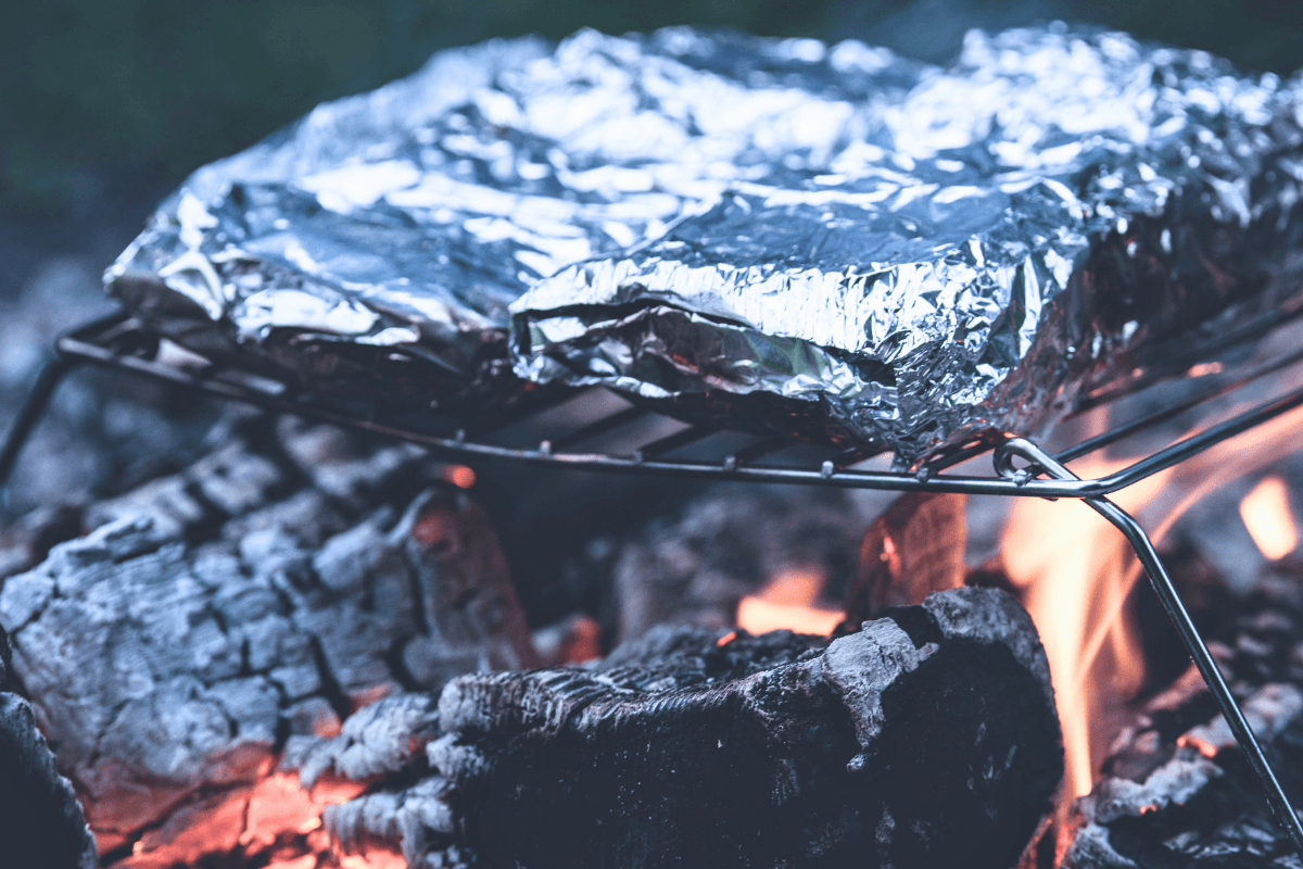 Foil packet camping meals cooking over a campfire